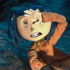 an animated doll with blue hair is sitting on the ground and holding her head in her hands