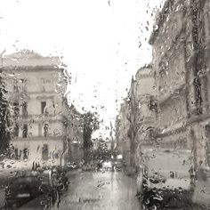 the rain is pouring down on an urban street