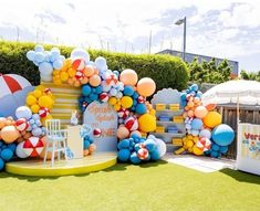 an outdoor birthday party with balloons and decorations