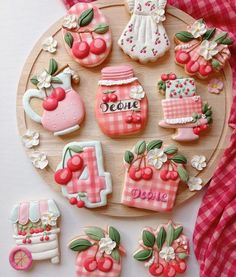 decorated cookies are arranged on a wooden plate