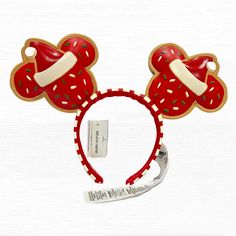 a red mickey mouse ears headband with donuts on it