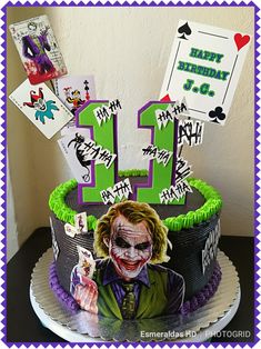 the joker birthday cake is decorated with green icing and purple frosting, along with some cards