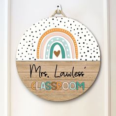 a wooden sign that says mrs lawless's classroom hangs on the front door