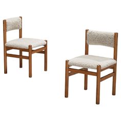 two wooden chairs side by side with one chair upholstered in white fabric and the other made out of wood