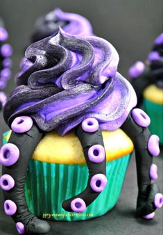 cupcakes decorated with purple and black icing