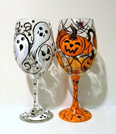 two wine glasses decorated with halloween decorations