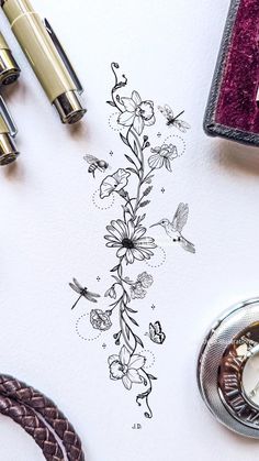 a pen and ink drawing on top of a white paper with flowers in the middle