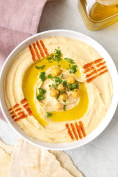 hummus with chickpeas and olive oil in a white bowl