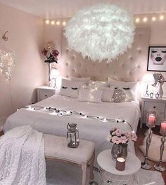 a bedroom with white furniture and lights on the ceiling