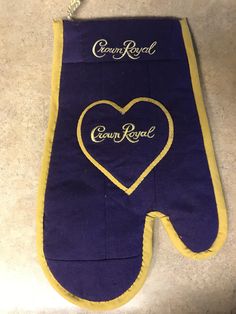 an oven mitt with the words crown royal written on it and a heart in the middle