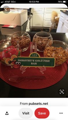 a red tray topped with lots of food on top of a counter next to a glass bowl