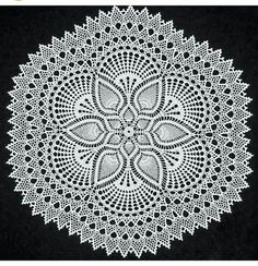 a white doily on a black background