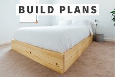 a bed sitting on top of a wooden frame in a bedroom