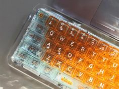 an orange and white keyboard sitting on top of a table