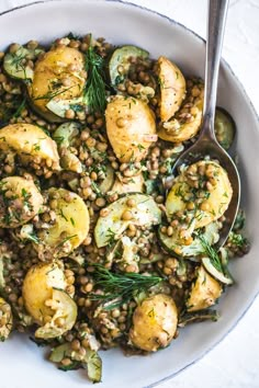 a white bowl filled with potatoes and lentils