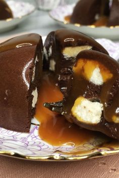 chocolate covered dessert with caramel sauce and ice cream on it sitting on a plate