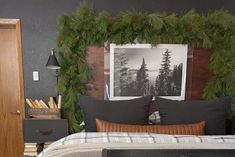 a bedroom decorated with evergreen garland and pine cones