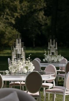 tables and chairs are set up with flowers in vases on the top one table