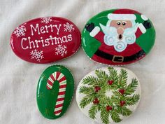 three christmas buttons with santa clause on them