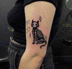 a woman with a cat tattoo on her arm