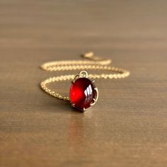 Radiating tender warmth, an incandescent garnet cabochon is held within golden branches in this pendant that evokes a feeling of eternity. 14k yellow gold, fine silver Garnet, 7.35ct, 10mm x 12mm (3/8" x 7/16")Chain is 18" long Newport Ri, Gift Card Shop, Red Garnet, Fine Silver, Bracelet Gift, Metal Jewelry, Ring Necklace, Newport, Jewelry Care