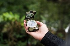 a person holding a compass in their hand