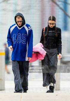 a man and woman walking down the street