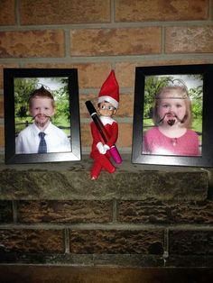 an elf is sitting on the mantle next to two pictures