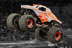 the monster truck is jumping high in the air