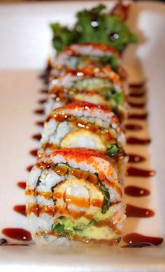 sushi rolls with sauce drizzled on them