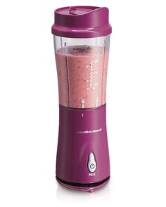 a blender filled with pink liquid on top of a white background