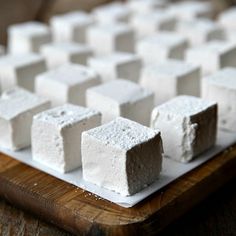 several pieces of marshmallow sitting on a cutting board