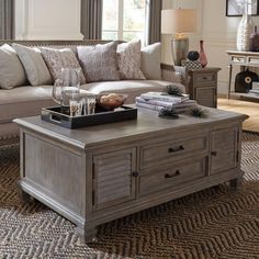 a living room with a couch, coffee table and other items on the carpeted floor