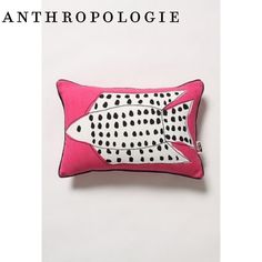 a pink pillow with black dots and a white fish on the front is featured in an article about anthropologie