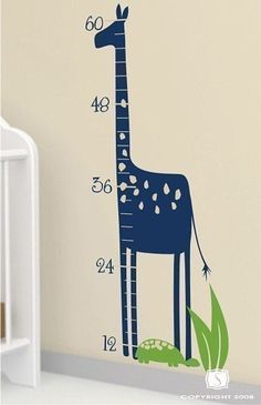 a giraffe height chart wall decal in a child's room