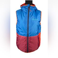 New With Tags Cotopaxi Teca Calido Hooded Vest In Rocket Science, Size Medium. Bust Measures 20" From Armpit To Armpit And Length Is 23.75". Multicolor Windproof Outerwear For Outdoor, Multicolor Nylon Outerwear For Outdoor Activities, Multicolor Nylon Windbreaker For Outdoor Activities, Multicolor Nylon Outerwear For Outdoor, Multicolor Adjustable Hood Outerwear For Outdoor Activities, Functional Multicolor Windbreaker For Outdoor Activities, Functional Red Windbreaker For Outdoor, Functional Red Outerwear For Hiking, Blue Nylon Outerwear For Camping