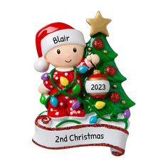 a personalized christmas ornament with a little boy next to a christmas tree