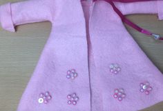 a child's pink coat with flowers on it