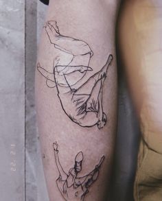 a man's leg with a drawing of a person falling off his surfboard