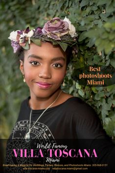 a woman with flowers in her hair is posing for a magazine cover photo, surrounded by greenery