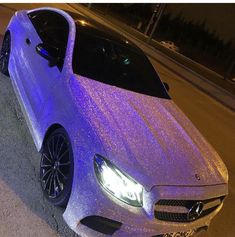 a car covered in purple glitter parked on the street