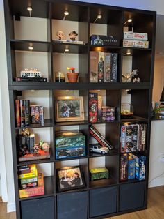 a bookshelf filled with lots of different types of toys on top of it