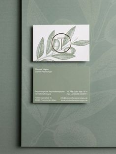 the business card is designed to look like an olive tree branch with leaves on it