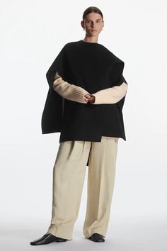 WOOL-BLEND CAPE - Black - Outdoor layers - COS Chic Oversized Cashmere Cape, Chic Fall Cape Shawl, Chic Cape Shawl For Fall, Elegant Oversized Cape Shawl, Oversized Chic Wool Poncho, Black Wool Cape Poncho, Elegant Oversized Shawl Cape, Black Wool Poncho For Fall, Wool Black Poncho For Fall