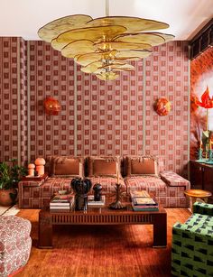 a living room filled with furniture and a chandelier hanging over the top of it