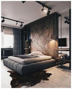 a large bed sitting in the middle of a bedroom next to a tv on top of a wooden wall