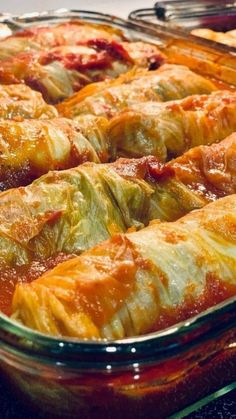 stuffed cabbage rolls in a glass casserole dish with the words stuffed cabbage rolls