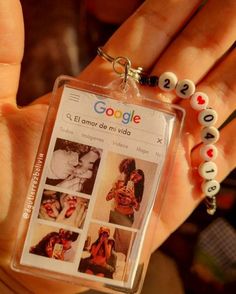 a hand holding a keychain that has pictures on it and beads attached to it