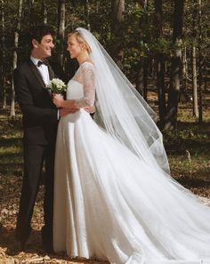 the bride and groom are posing for their wedding photo