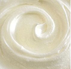 a close up view of the inside of a whipped cream swirl on a white surface